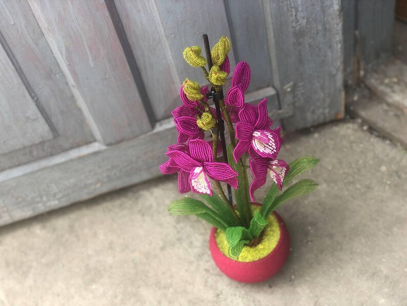 Orchidée en perles magenta dans un pot rose, art floral fait main
